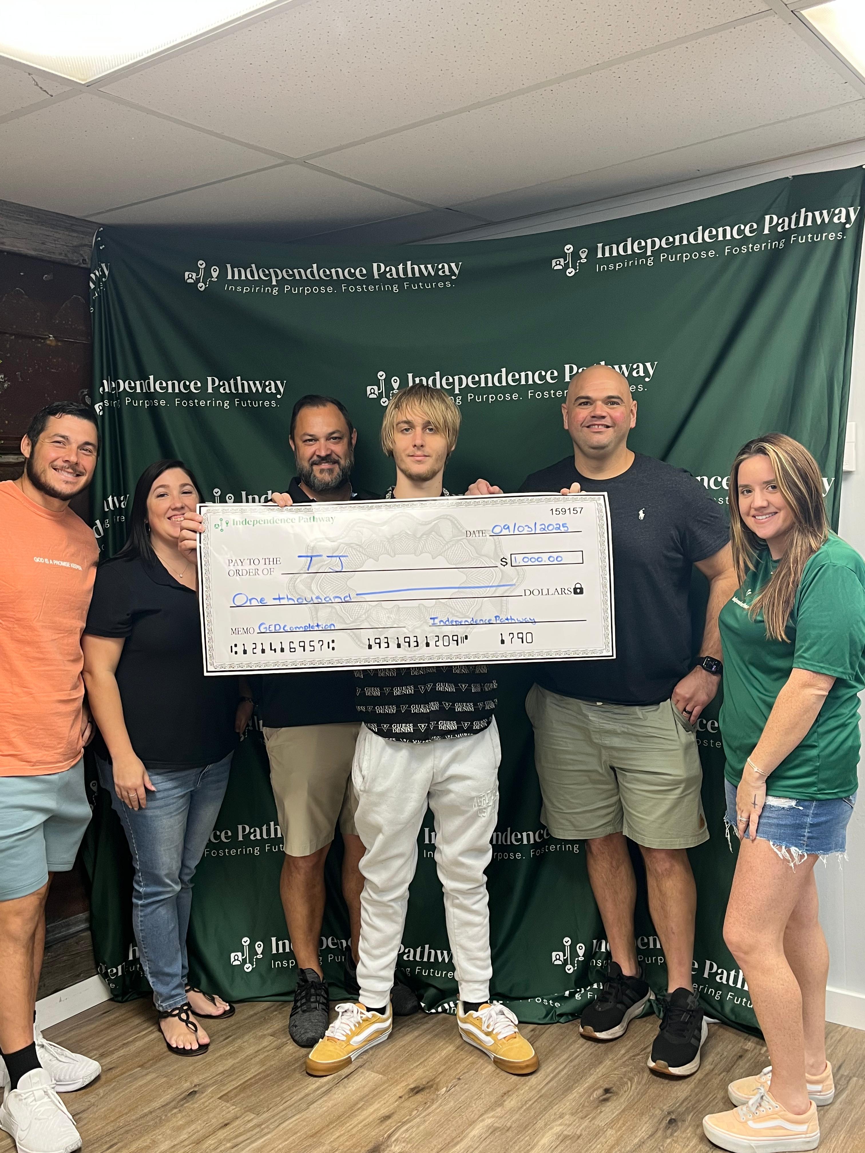 Carlos receiving check